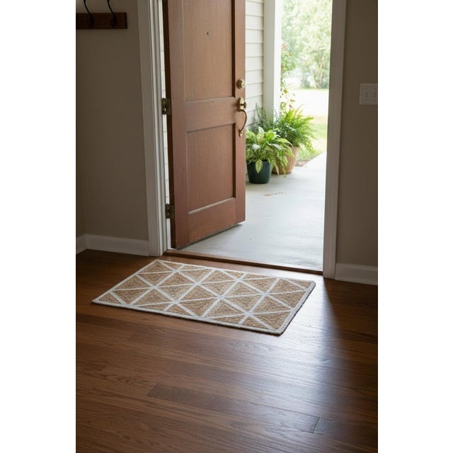 This handcrafted geometric jute doormat adds natural texture and modern character to any entryway. Expertly handwoven from...