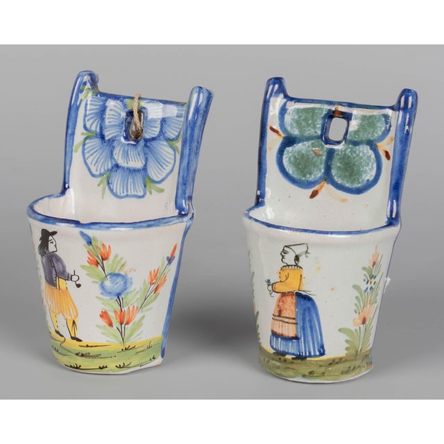 A pair of 19th century French faience wall pockets, or a bénitiers, or holy water fonts, used for devotional blessings...