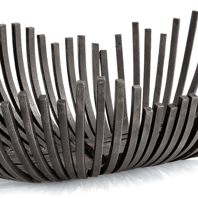 This sculpted webbed bowl finished in the enduring blackened iron seamlessly merges form and function. With it's sculpted...