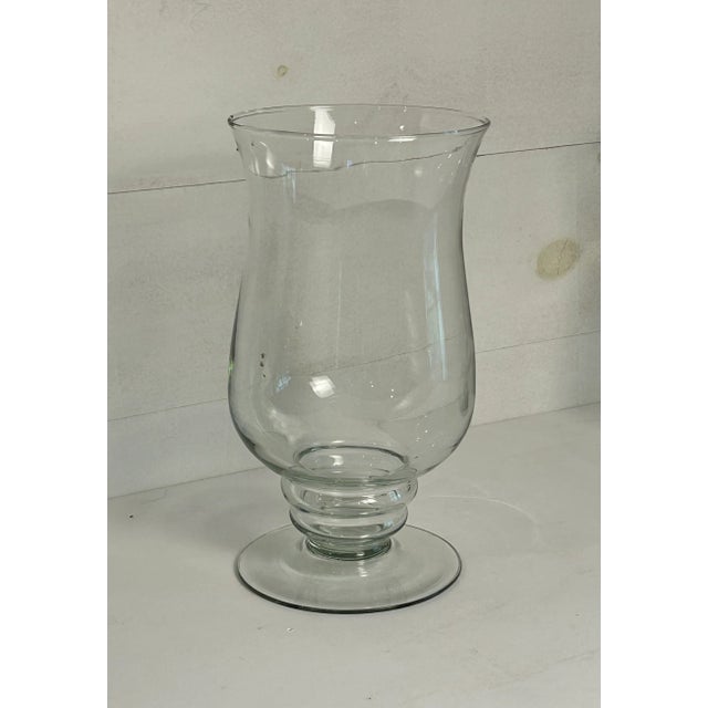 Large free standing hand blown glass hurricane lamps. Lovely goblet base. Can be used as vases.