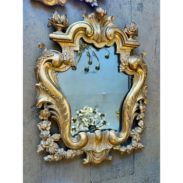A carved giltwood pair of Italian mirrors with original glass and back boards. The gilt with soft and warm patina, minimal...