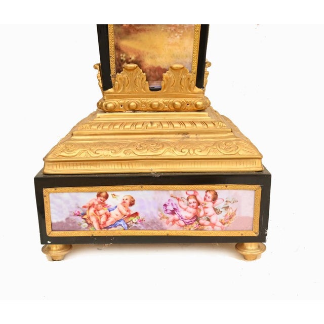 A highly decorative pair of French pedestals combining richly cast gilt bronze mounts with porcelain panels, creating an...