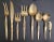 Vintage Nickel Bronze Flatware Set - 54 Pieces Minimalist beveled handles, ending with a sleek rounded tip, on this set...