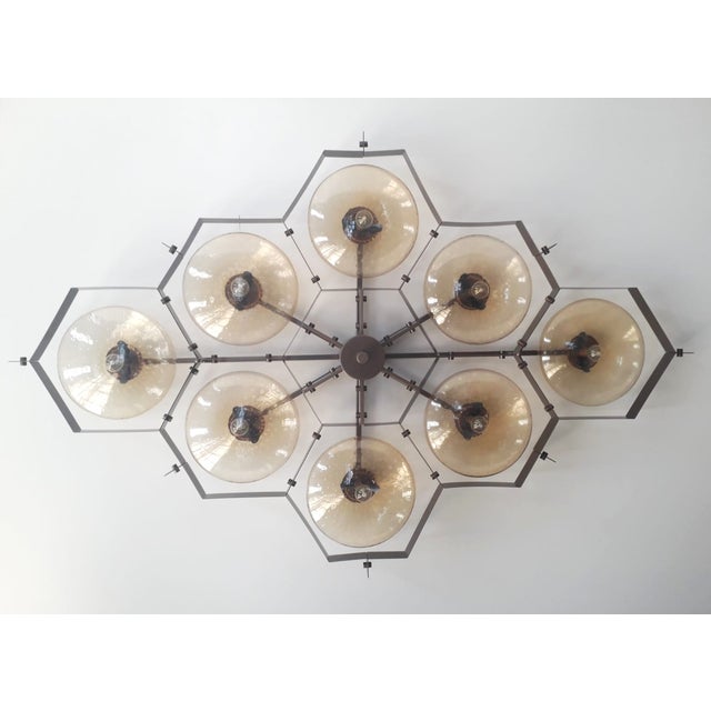 Italian midcentury flush mount with eight amber Murano glass shades carefully hand blown with bubbles inside the glass...