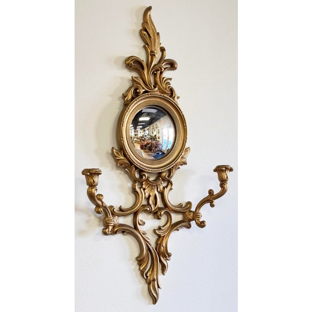 Vintage hand-carved Syroco wall-mounted candle sconce. Holds two taper candlesticks. Features a concave mirror, lovely...