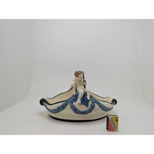 Decorative bowl with cherub figures, floral garlands, and underglaze colored painting, designed by Wilhelm Süß,...