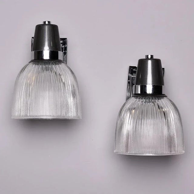 Found in England, this pair of industrial style sconces date from the late 1970s. Each light has a rectangular chrome...