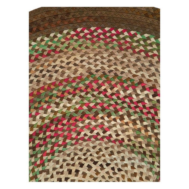 A vintage American Braided oval room size carpet handmade during the mid-20th century. Measures: 9' 5" x 12' 3" North...