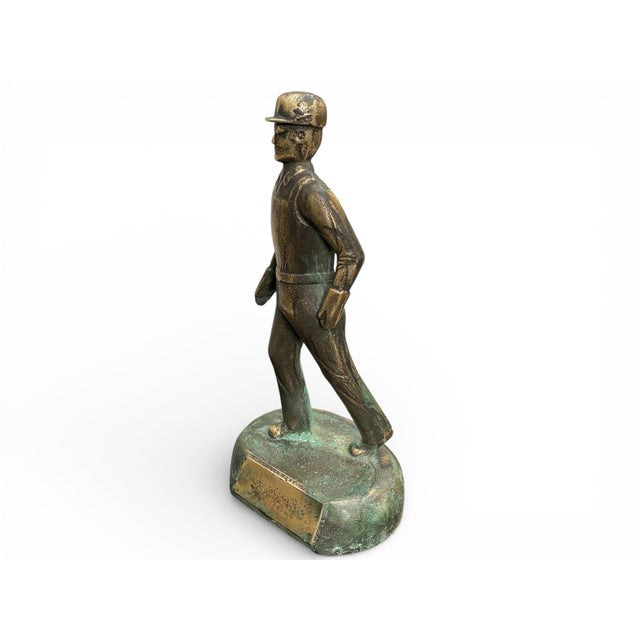 A substantial mid-century bronze sculpture depicting an industrial worker or foreman in purposeful stride, raised on an...