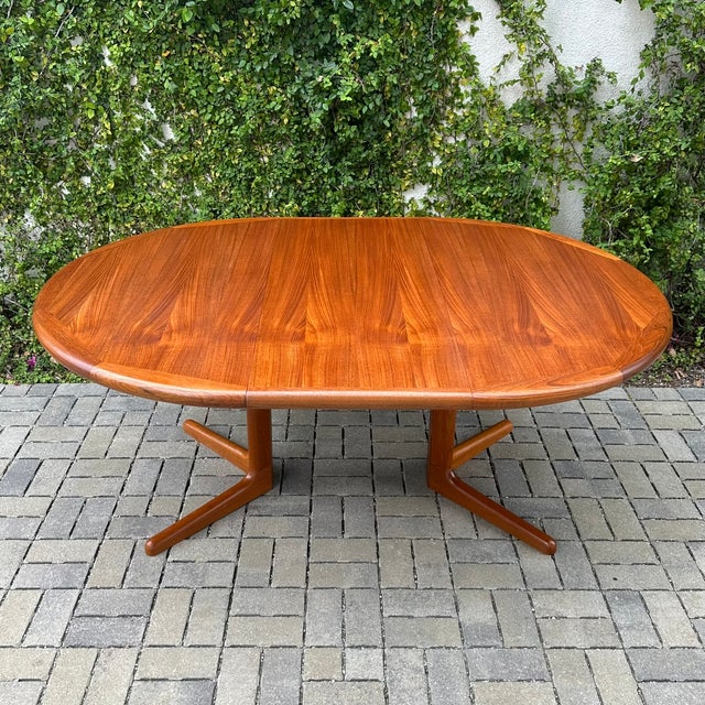 Scandinavian mid century modern round expandable dining table on split pedestal base, made in Denmark by Edvard...