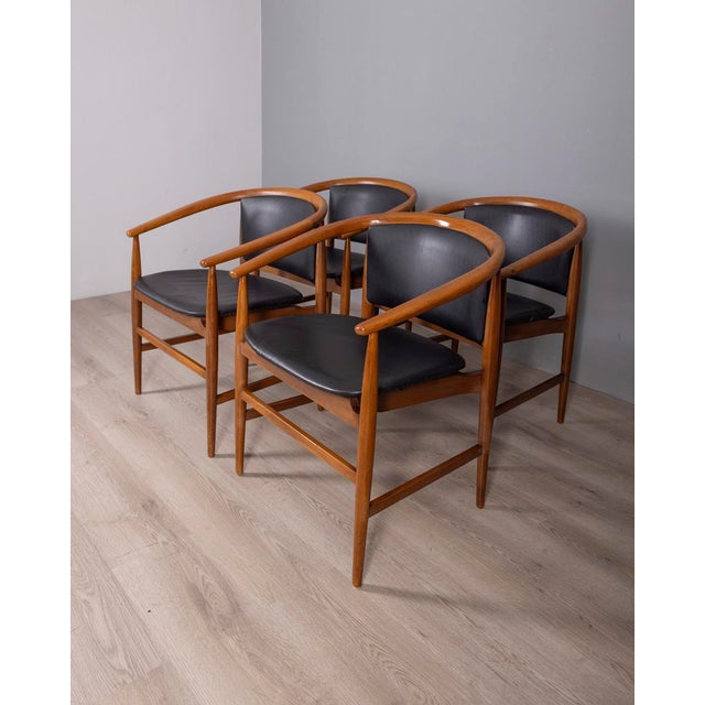 Set of four chairs with teak frame and black leather seat, designed by ISA Bergamo, 1960s. This piece has an attribution...