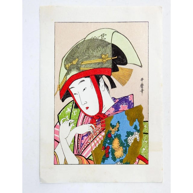 Small late 20th century Japanese woodblock print of woman with fan. Great colors including gold metallic, pink, red and...