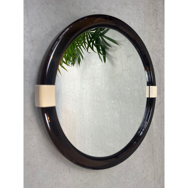 1970s mirror with smoked acrylic glass frame. Corner is slightly tiltable via beige hinges. Easy to hang. In excellent...