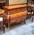 Make a statement with this magnificent French commode, showcasing exceptional floral marquetry, graceful serpentine lines....