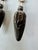 A pair of vintage corn holders with detailed sterling silver handles shaped as ears of corn, complete with individual...