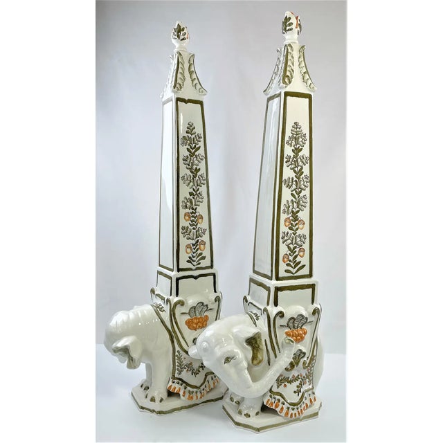 This is a pair of whimsical mid century majolica elephant obelisks produced for it Italy for Meiselman Imports. They are...