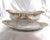 This is a Theordore Haviland gravy boat with an attached underplate from 1903 in the Schleiger 630-2 pattern. It is white...