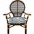 Elegant vintage rattan peacock armchair featuring a sculptural rounded fan back, woven cane detailing, and rich dark-...