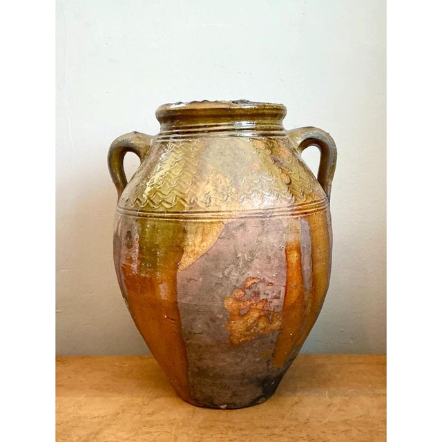 This vintage glazed terracotta jar is a robust, hand-thrown vessel in the classic oil-jar form, with a full, egg-shaped...