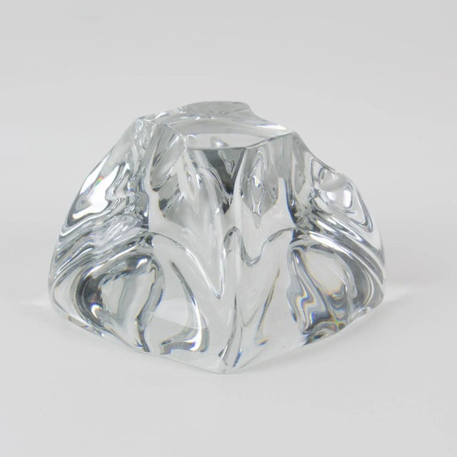 Daum designed this stunning crystal abstract freeform desktop paperweight. The piece was crafted in France circa 1950. The...