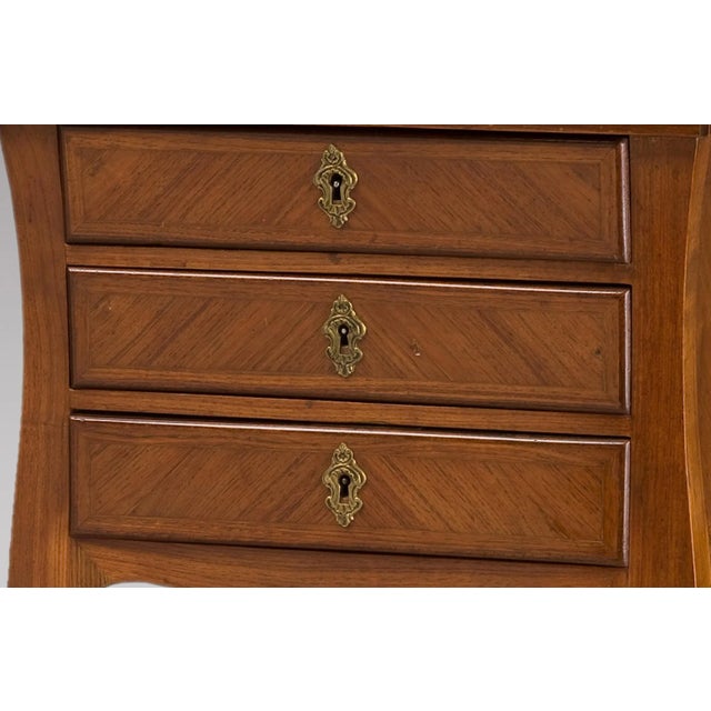 This side table, in Louis XV style, was produced in France during the 19th Century and is made from rosewood with a marble...