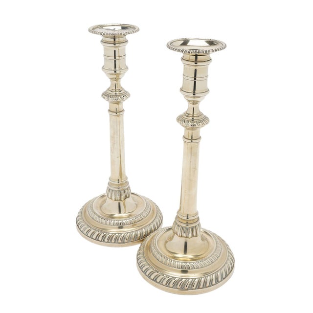 Pair of cast paktong circular base candlesticks with a removable gadroon edge bobesh. The tall, slender shaft is capped...