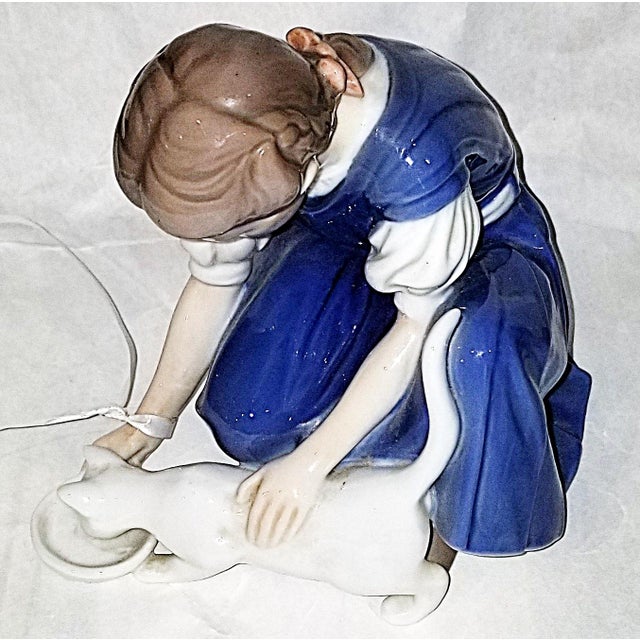 Bing & Grøndahl porcelain figurine titled 'One More Drop," featuring a girl feeding a cat. c. 1960-70s, model number 1745,...
