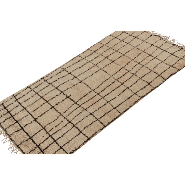 Hand-knotted in wool and hailing from Morocco circa 1950-1960, this 5x10 vintage Moroccan rug is a new curation from Rug &...