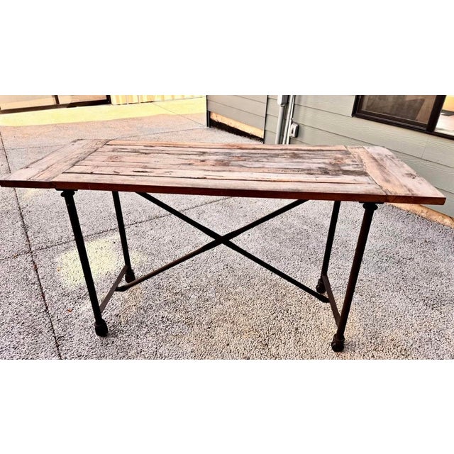 The pairing of antiqued elm and distressed cast metal achieves the "form meets function" industrial appeal of Flatiron. A...