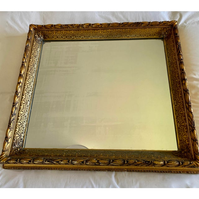 Antique French Mirror with French Bee Design on Frame. Color is deep gold patina and the frame is guilded. Mirror is...