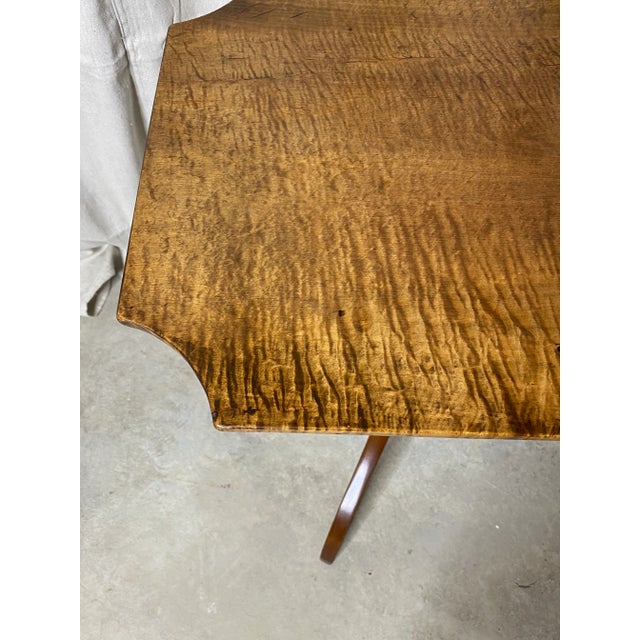 Elegant late 18th/early 19th century federal era New England tilt top candle stand with triple spider legs that are...