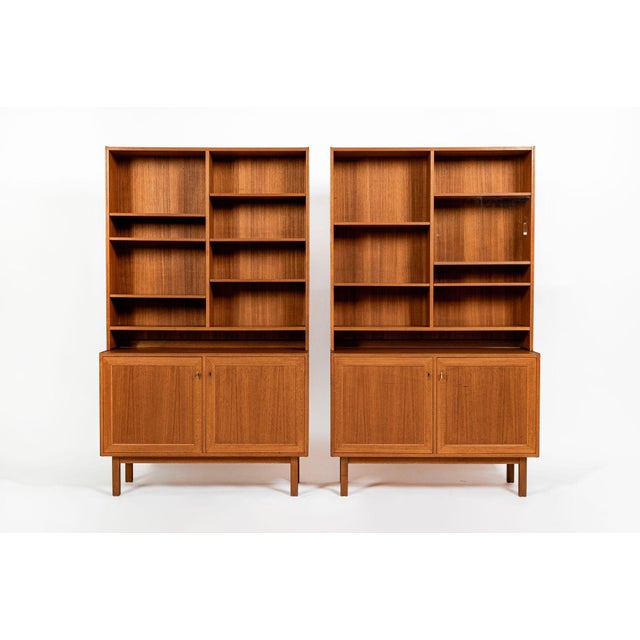 This lovely matching pair of Swedish mid-century modern bookcase cabinets was produced during the 1960s. Well-crafted in...