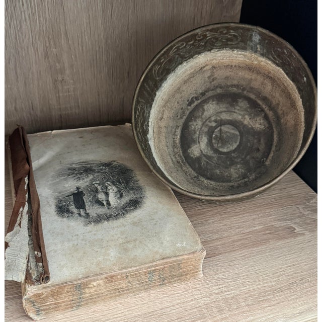 Early 20th-century brass jardinière planter with a repoussé foliate band and vertical fluting, raised on three feet and...