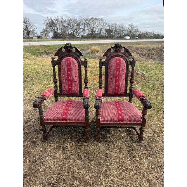 Large Pair of French Renaissance Armchairs from France made of solid walnut, the wood has been finished with a lustrous...