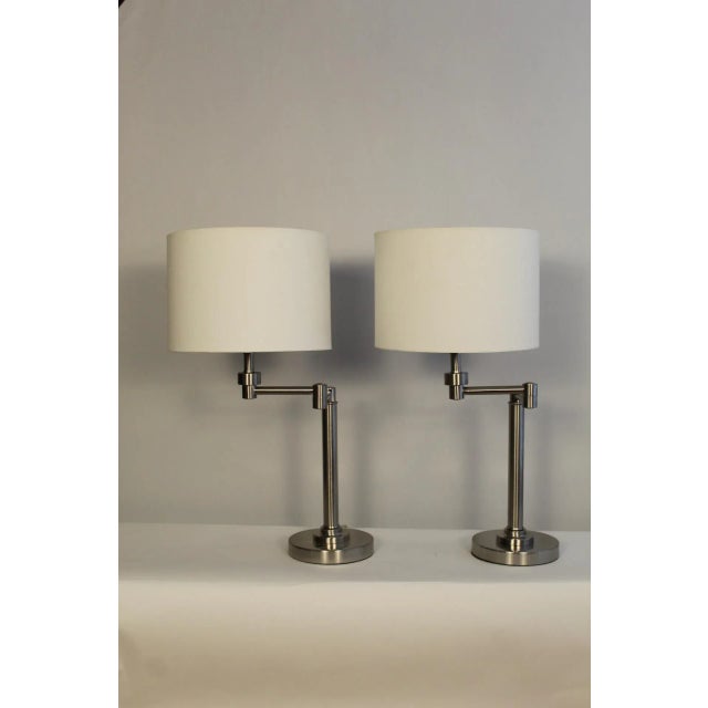 A pair of Henson style swing are lamps. Simple and stylish Hanson was known for. These lamp lend themselves to same genre....