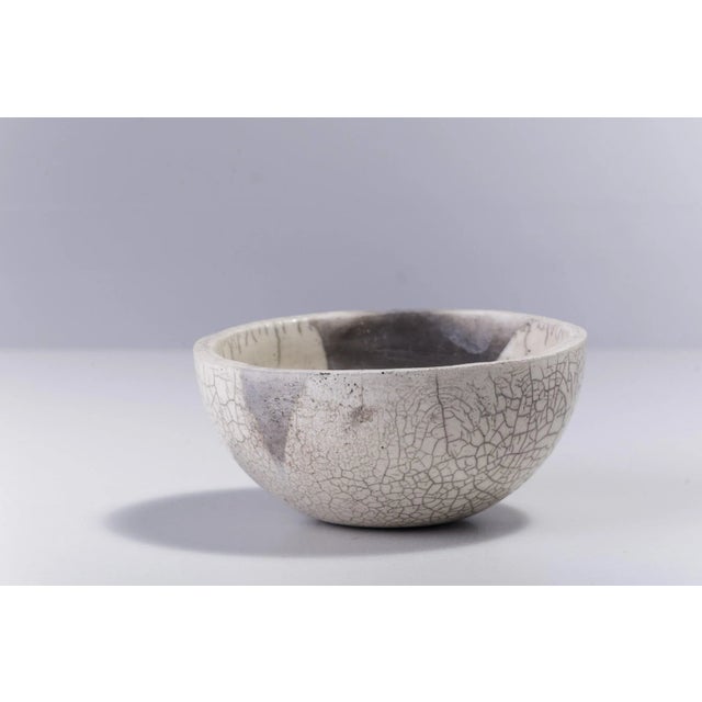Irregular, dramatic gray cracks of bold visual impact embellish the polished ceramic surface of this spectacular chawan...