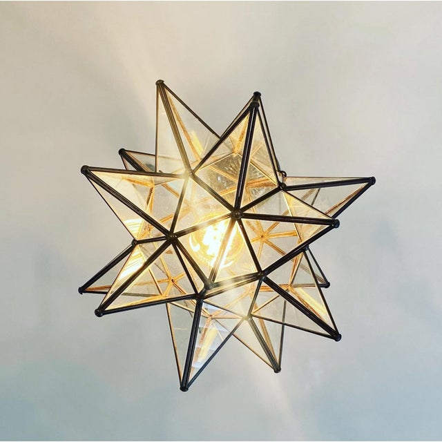 This hand-crafted Moravian star pendant illuminates your home with whimsical sparkle. Oxidized metal finish and clear...