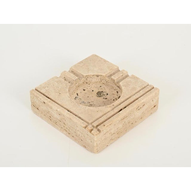 Elegant midcentury square shaped ashtray in travertine marble. This stylish piece was designed in Italy during the 1970s...
