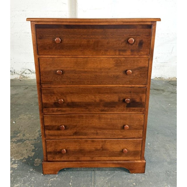 This cherry chest features five generously sized drawers with simple wooden knobs and attractive natural grain variation...