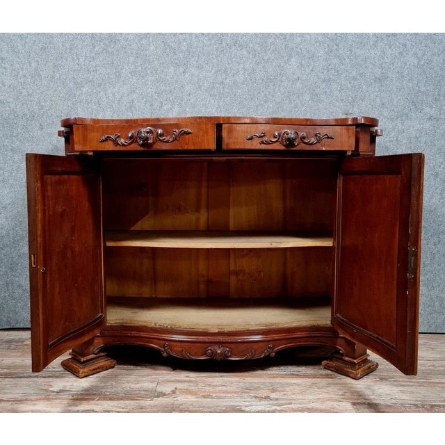 Napoleon III period mahogany sideboard, curved on all sides Front opening with 2 leaves and 2 drawers Panelled sides...