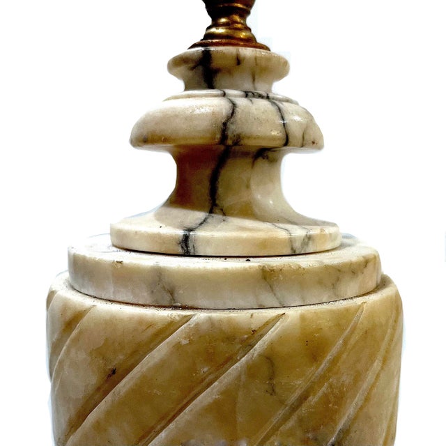 What could be more classic than a neoclassical urn carved from alabaster? Which features an ivory ground with brown and...