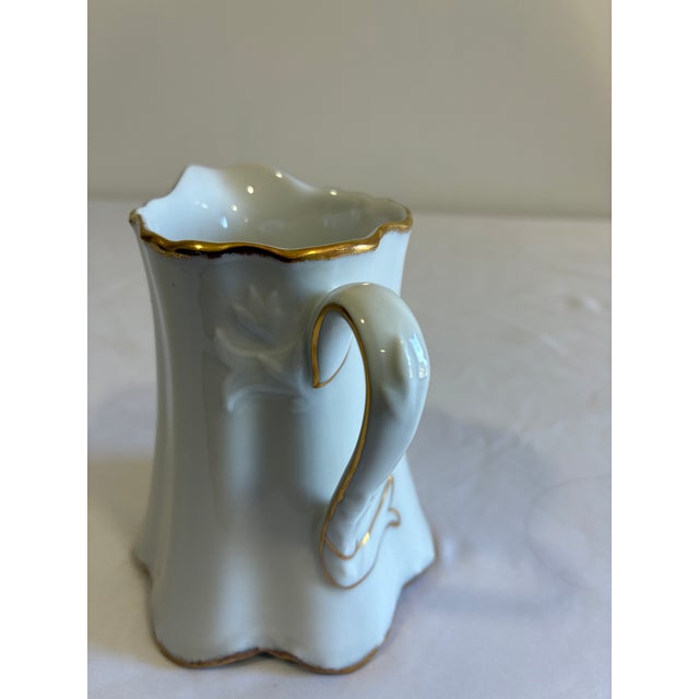 Chairish Description: This dainty porcelain creamer by Thomas, Germany, features a graceful fluted body, scalloped rim,...