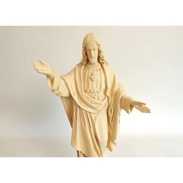 A large and highly atmospheric French plaster Sacred Heart of Jesus statue, measuring 68 cm high and 35 cm wide. Executed...