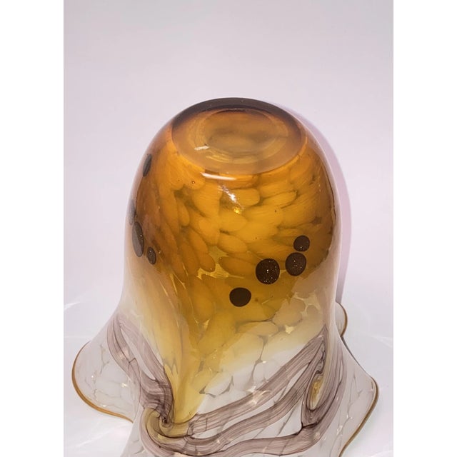 Stunning vintage Murano-style hand-blown art glass vase featuring a dynamic swirl pattern and an elegant ruffled edge. The...