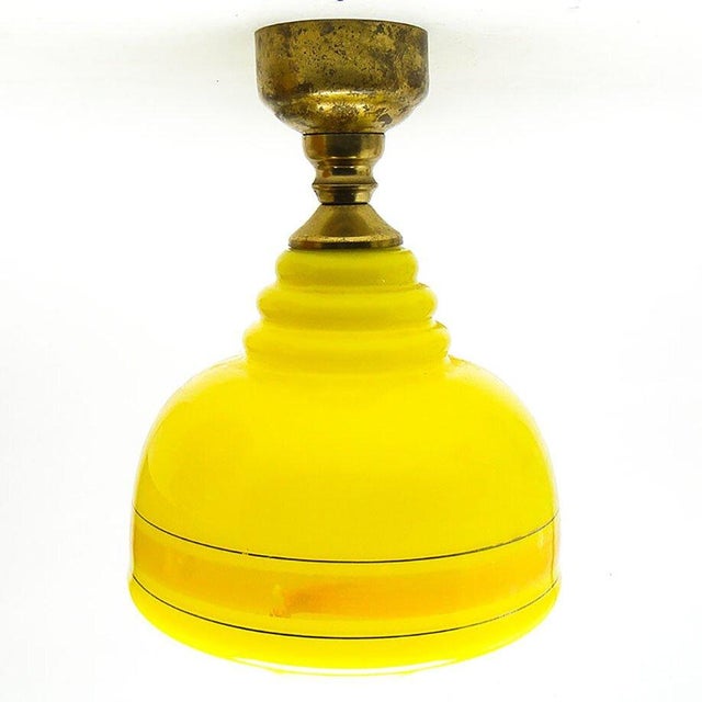 The pendant lamp was produced in the 70s. The construction is brass, glass lampshade. It is preserved in very good...