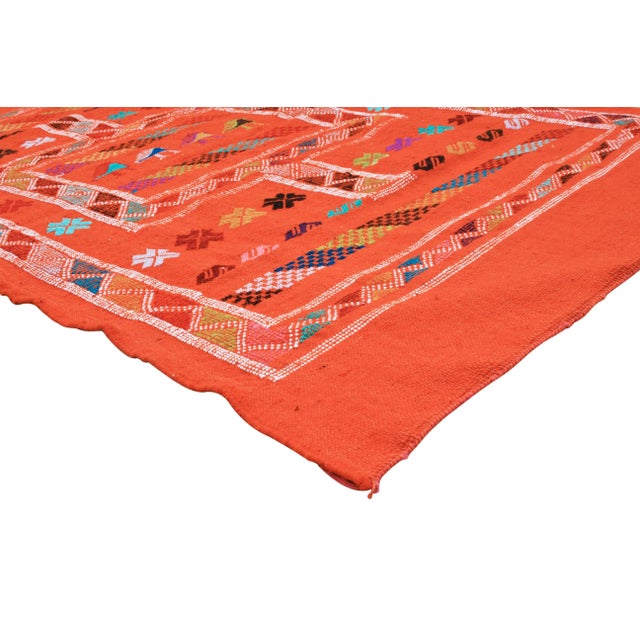 Handwoven Moroccan flat-weave wool, featuring an elegant rhythmic pattern of colorful birds, intricate Berber tattoos and...