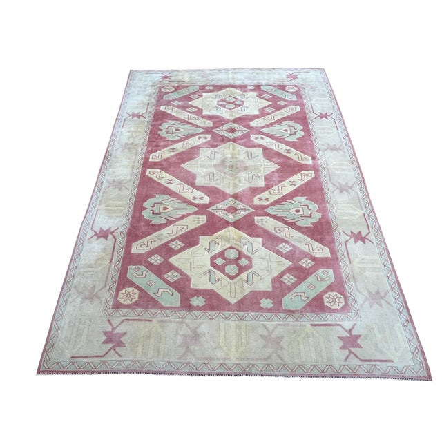 Vintage Turkish rug, hand-knotted in Turkey from 100% wool. Measuring 6’9” x 9’7”, the rug features a bold traditional...