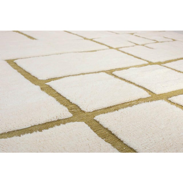Elegant hand-knotted wool rug in soft Ivory, highlighted by geometric lines in Green Olive. The clean, structured design...