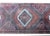 A wonderful vintage Afghani Baluchi runner with three large diamond medallions woven with repeated crimson and black...