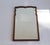 An antique wooden scalloped mirror with beveled glass. The wall mirror has a beautiful frame made out of walnut. Made in...
